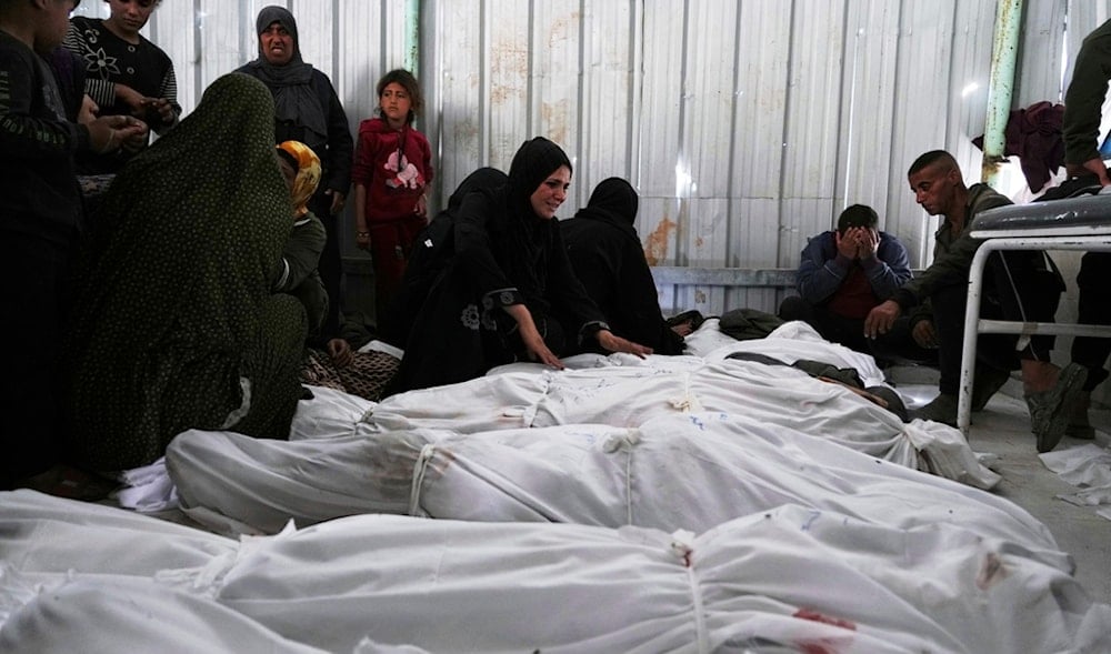 Palestinians grieve over the bodies of their relatives, who were killed in an Israeli airstrike, as they prepare for burial at a hospital in Beit Lahia, Gaza Strip, on Wednesday, April 2, 2025. (AP)