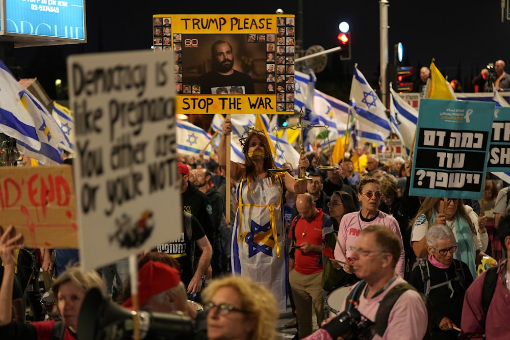People protest against Prime Minister Benjamin Netanyahu's government outside the Knesset, Israel's parliament in occupied al-Quds, on March 31, 2025. (AP Photo/Ohad Zwigenberg)