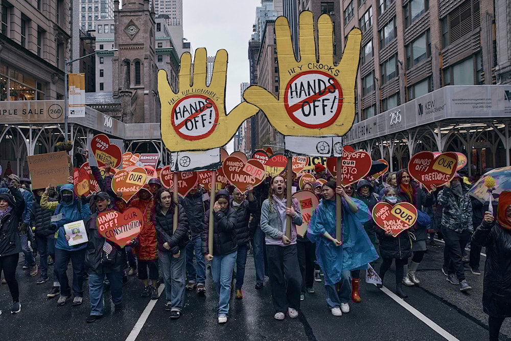 Protestors shout slogans as they march during a