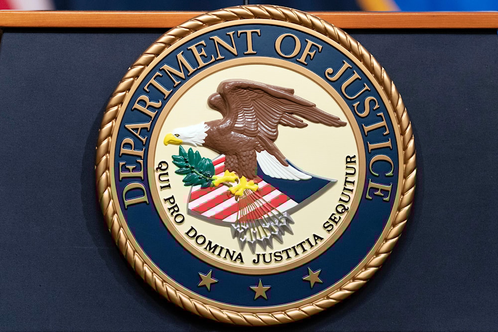 The Department of Justice seals is seen during a news conference at the DOJ office in Washington, May 16, 2023 (AP)