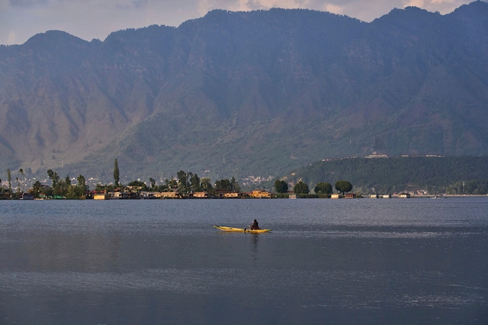 A Kashmiri woman row her wooden boat on Dal Lake in Srinagar, in Indian controlled Kashmir, Saturday, May 10, 2025.(AP Photo/Dar Yasin)