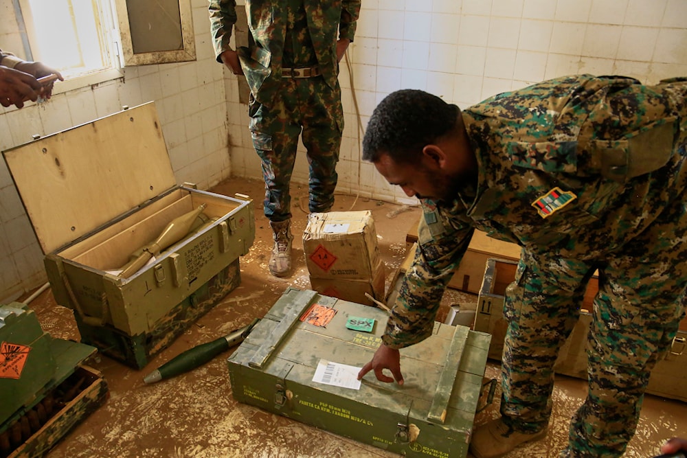 Sudanese army officers inspect a recently discovered weapons storage site belonging to the paramilitary Rapid Support Forces (RSF) in Khartoum, Sudan, Saturday, May 3, 2025 (AP)
