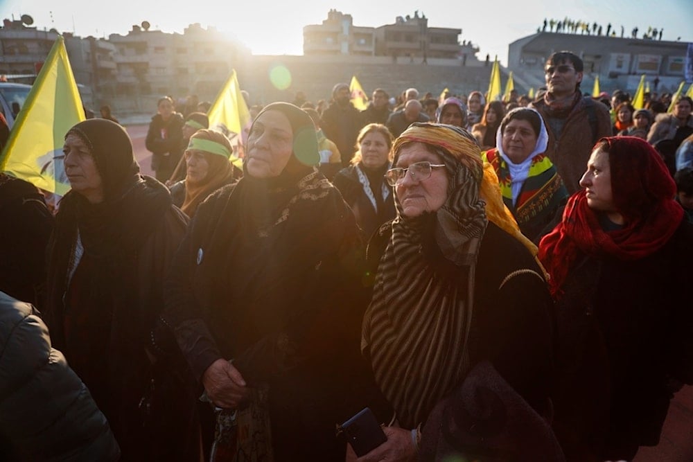Kurdish women watch live as a Pro-Kurdish Peoples' Equality and Democracy Party, or DEM, delegation members release a statement from PKK leader Abdullah Ocalan, in Qamishli, northeastern Syria, Thursday, Feb. 27, 2025 (AP)