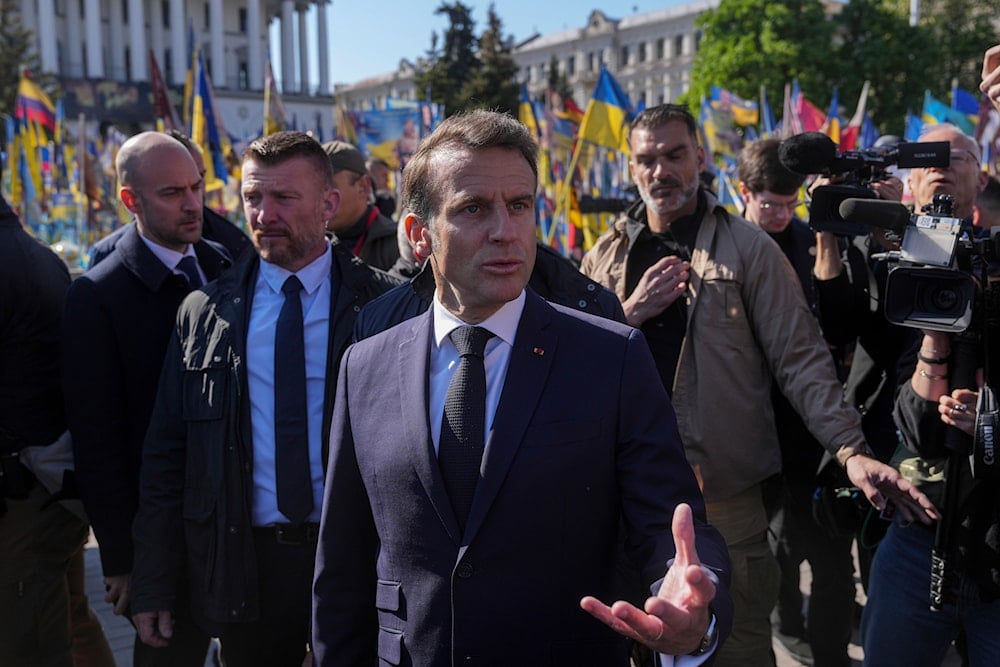 French President Emmanuel Macron speaks to journalists at the memorial of fallen Ukrainian soldiers at independence square in Kiev, Ukraine, on Saturday, May 10, 2025 (AP)