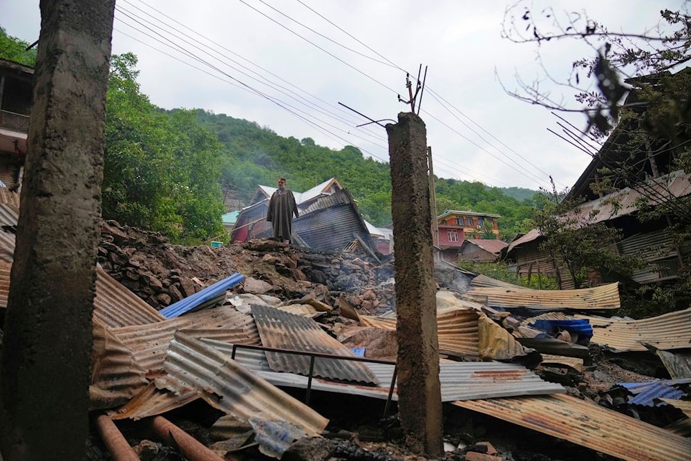 A person inspects his damaged house following overnight shelling from Pakistan at Gingal village in Uri district, Indian controlled Kashmir, on May 9, 2025. (AP Photo/Dar Yasin)