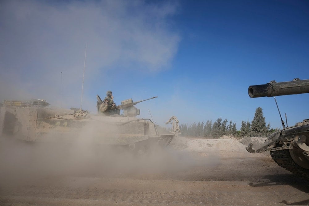 Israeli troops move with an APC, an armored personnel carrier in Gaza, seen from southern occupied Palestine, Thursday, May 8, 2025 (AP)