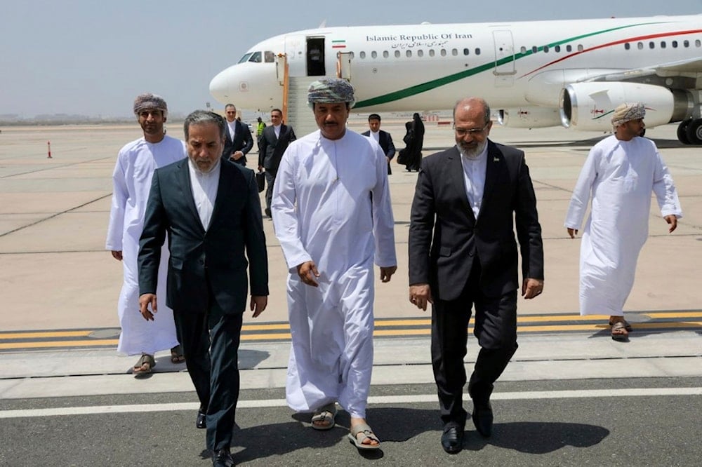 In this photo released by the Iranian Foreign Ministry, Iranian Foreign Minister Abbas Araghchi, left, is welcomed upon his arrival at Muscat, Oman, for negotiations with US Mideast envoy Steve Witkoff, Sunday, May 11, 2025 (AP)