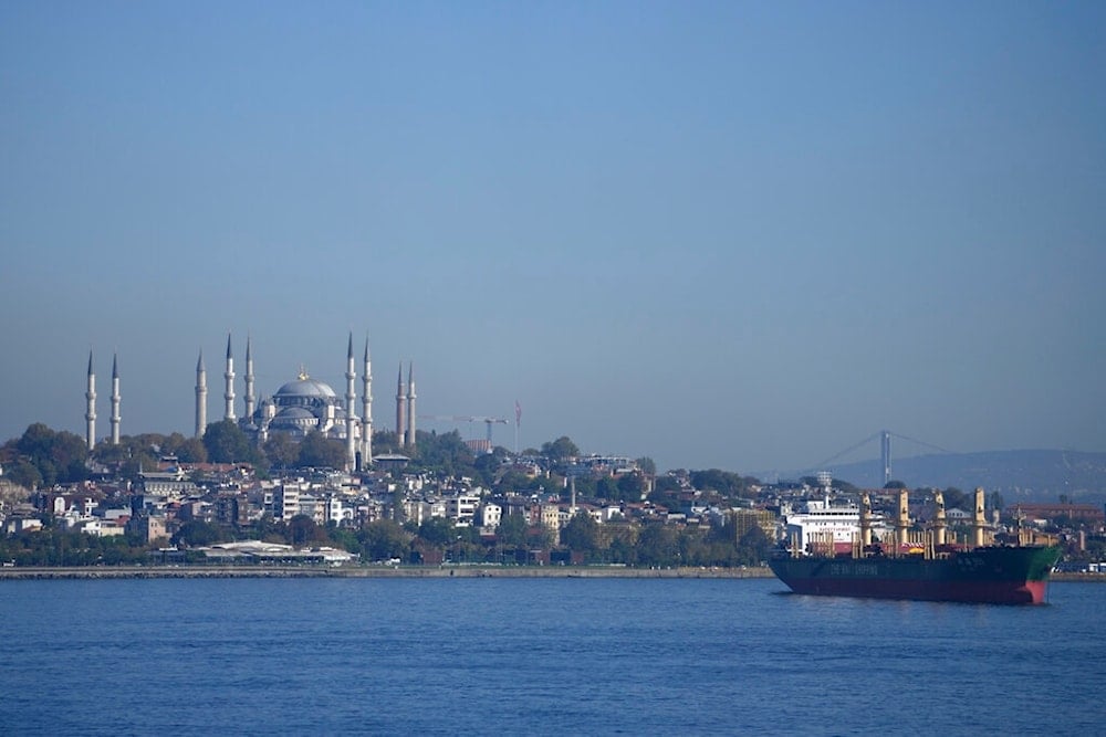 A cargo ship anchors in the Marmara Sea as Hagia Sophia historical mosque is seen in background, in Istanbul, Turkey, Saturday, Oct. 1, 2022. (AP Photo/Khalil Hamra)