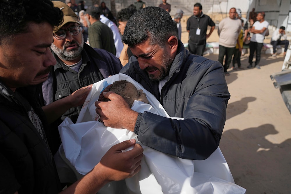 Mohannad Al-Agha, holds body of his niece Zeina Al- Agha, 2, killed in an overnight Israeli airstrike, during her funeral at Nasser Hospital in Khan Younis, Gaza Strip, Sunday, May 11, 2025. (AP)
