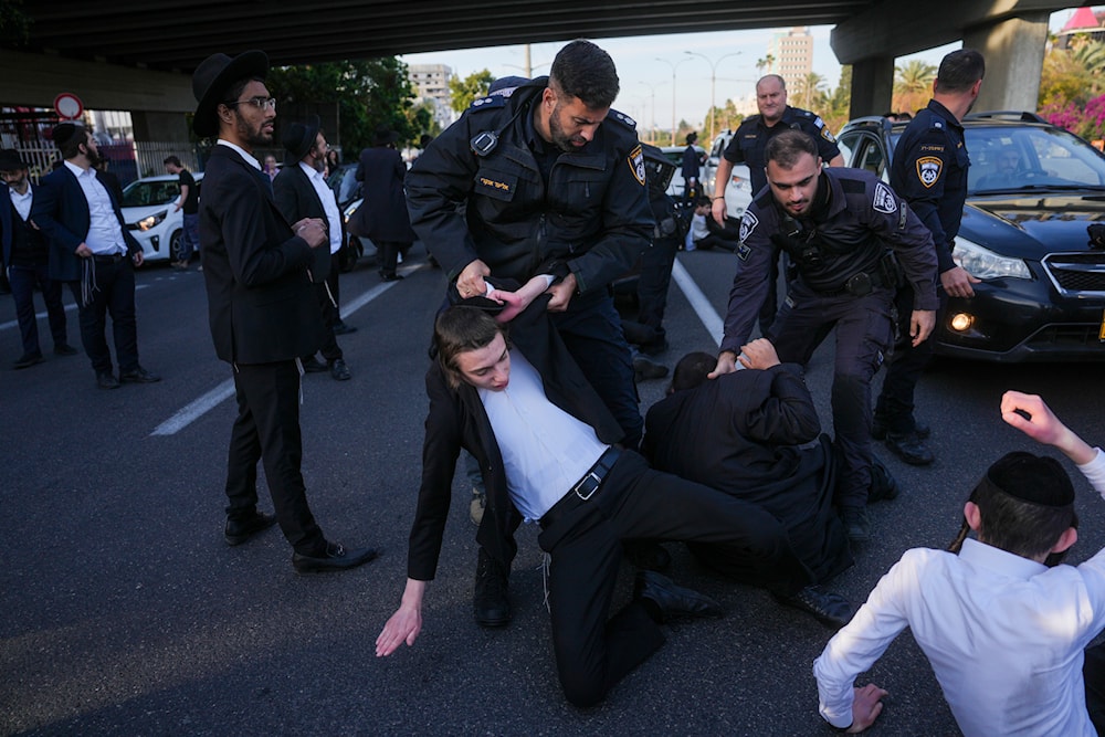 Israeli police officers attack Ultra-Orthodox Jewish men during a protest against army recruitment in Bnei Brak, Sunday, March 2, 2025. (AP)