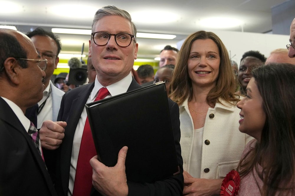 Labour Party leader Keir Starmer with his wife Victoria make their way through supporters as they arrive at the count for the Holborn and St Pancras Parliamentary constituency where the Starmer is standing for election, in London, Friday, July 5, 2024 (AP)