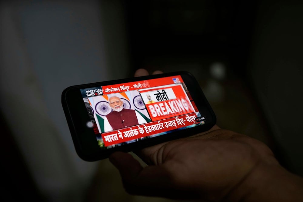 A man watches on a mobile phone Indian Prime Minister Narendra Modi address the nation about Operation Sindoor, in Jammu, India, Monday, May 12, 2025.(AP)