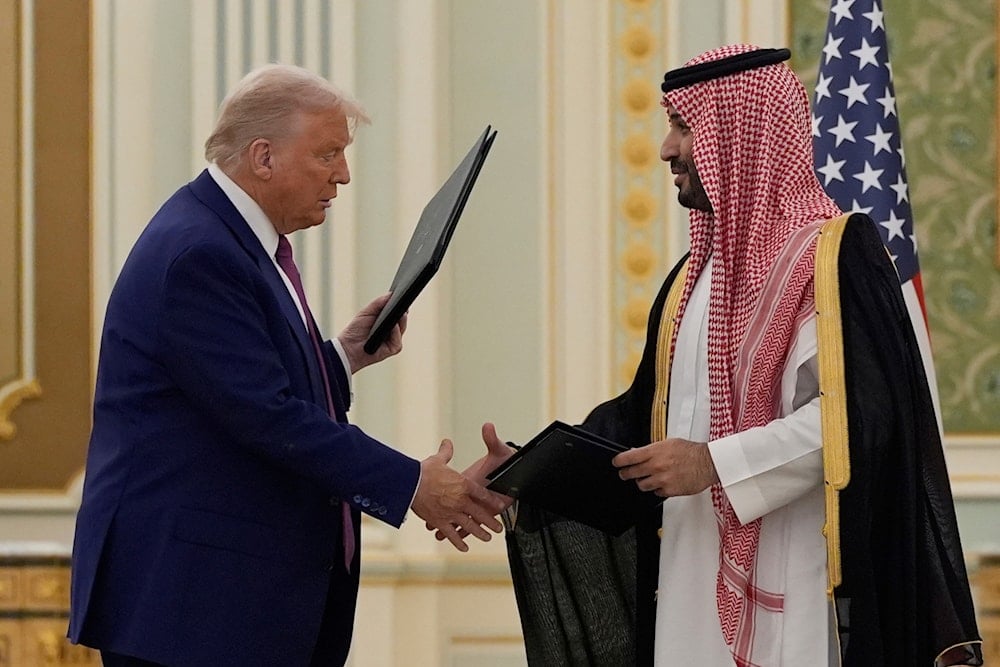 President Donald Trump and Saudi Crown Prince Mohammed bin Salman shake hands after exchanging documents during a signing ceremony at the Royal Palace in Riyadh, Saudi Arabia, Tuesday, May 13, 2025 (AP)