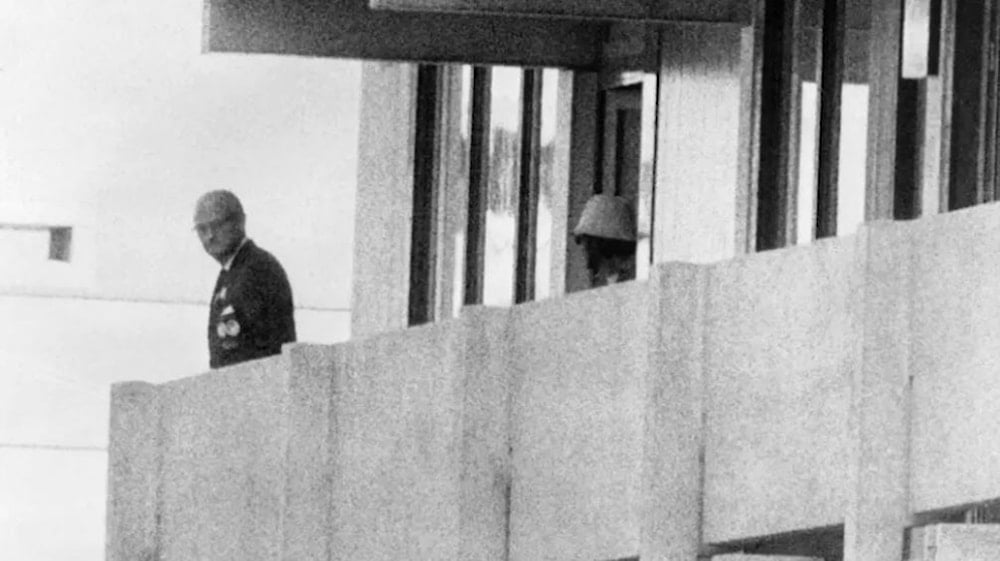A Palestinian militant appears on the balcony of the Olympic Village building where members of 'Israel's' Olympic team were taken hostage, Munich, Germany, September 5, 1972 (AFP)