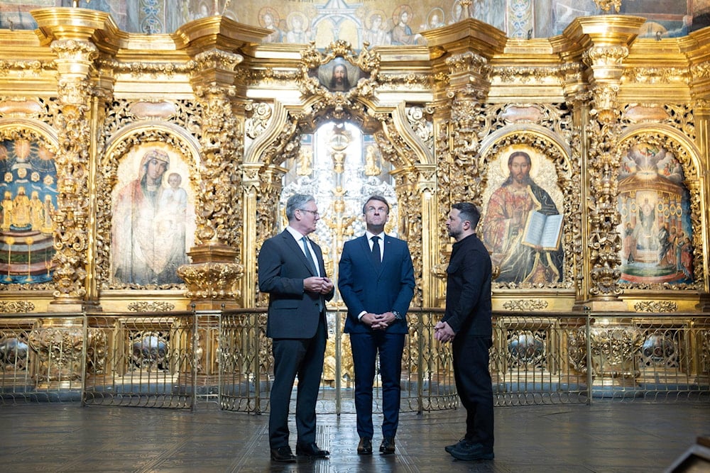 Ukrainian President Volodymyr Zelensky, right, Britain's Prime Minister Keir Starmer, left, and French President Emmanuel Macron, center, visit the St. Sophia Cathedral in Kyiv, Ukraine, Saturday, May 10, 2025. (Stefan Rousseau/PA via AP, Pool)