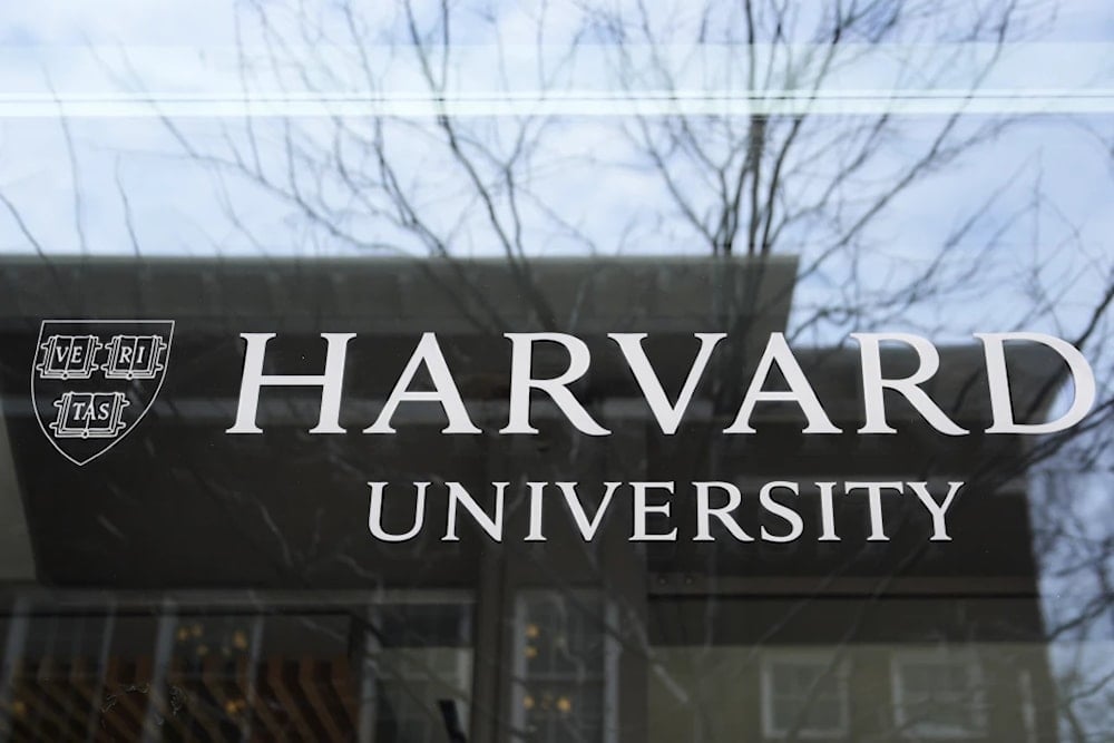 The Harvard University logo is displayed on a building at the school, April 15, 2025, Cambridge, Massachusetts (AP/Charles Krupa) 