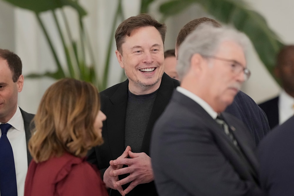 Elon Musk gestures as he arrives for a state dinner hosted by Qatar's Emir Sheikh Tamim bin Hamad Al Thani in honor of President Donald Trump at Lusail Palace in Doha, Qatar, Wednesday, May 14, 2025 (AP)