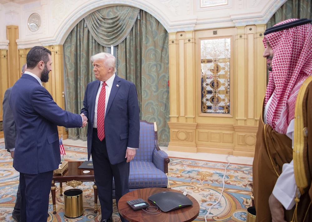 In this photo released by the Saudi royal Palace, interim Syrian President Ahmad al-Sharaa shakes hands with US President Donald Trump in Riyadh, Saudi Arabia, May 14, 2025 (Bandar Aljaloud/AP)
