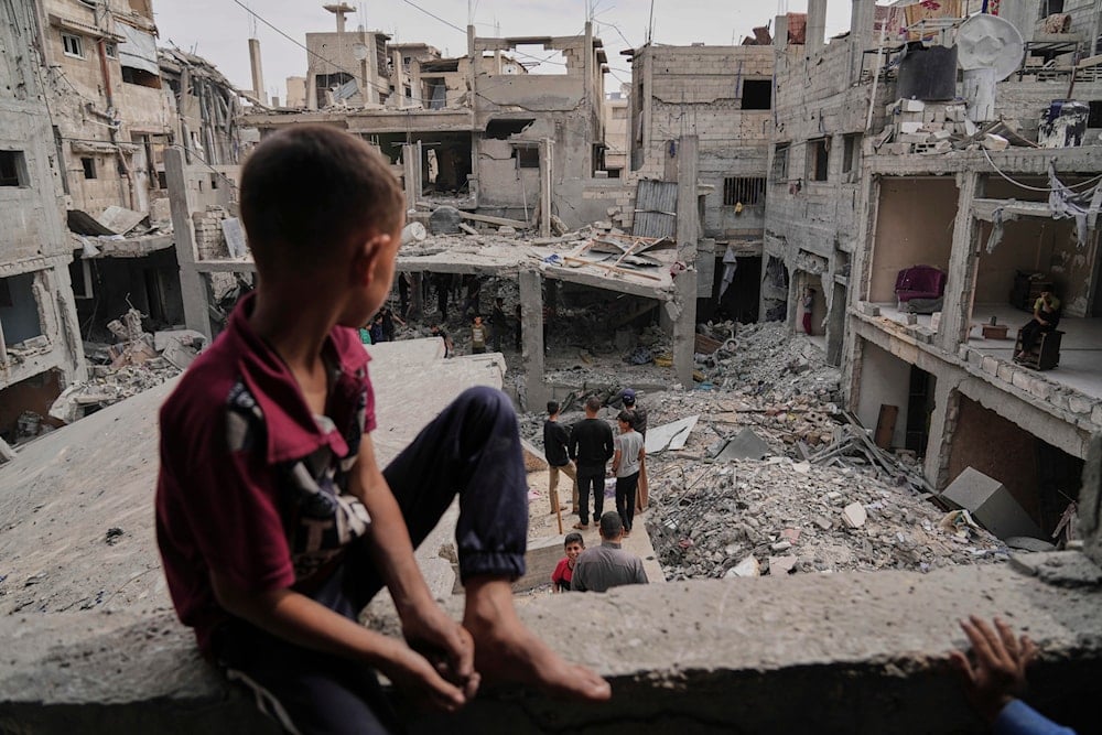 Palestinians inspect the rubble of the Al-Lahham family's home, destroyed by Israeli airstrikes in Khan Younis, Gaza Strip, on May 15, 2025. (AP Photo/Abdel Kareem Hana)