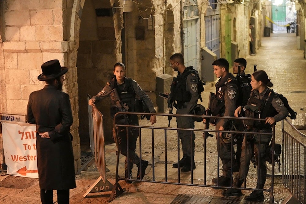 Israeli security forces stand guard near the scene of a stabbing attack in the Old City of occupied al-Quds, occupied Palestine, Friday, May 16, 2025 (AP)