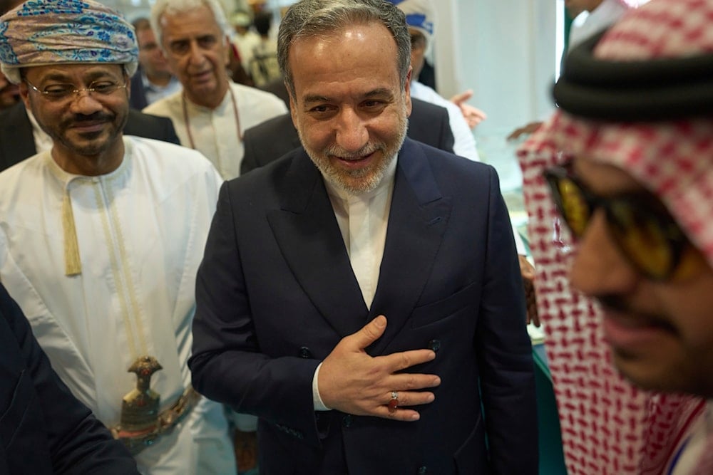 Iranian Foreign Minister Abbas Araghchi, center, and Omani Foreign Minister Badr al-Busaidi, left, walk through the Muscat International Book Fair in Oman, Friday, April 25, 2025 (AP)