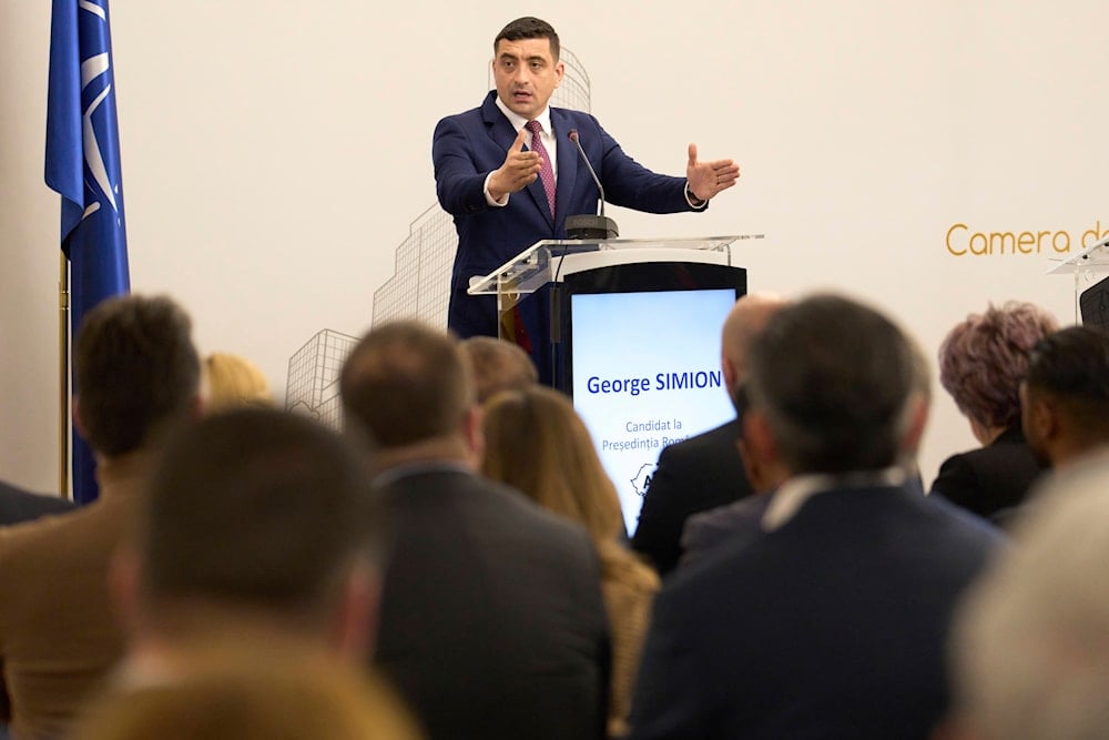 Romanian presidential front-runner accuses Macron of interference