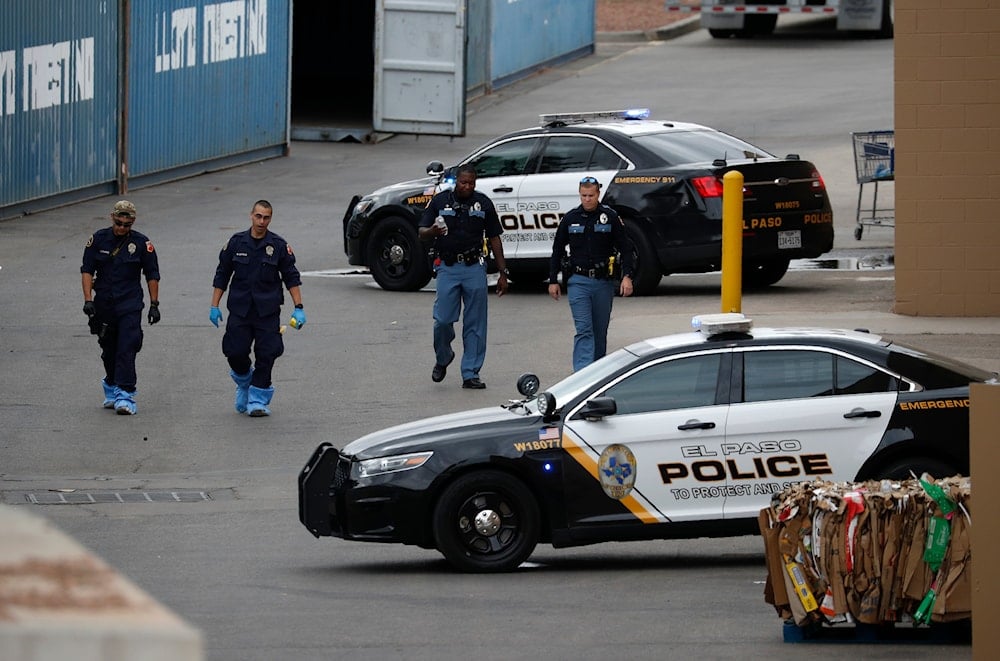 In this Aug. 6, 2019, file photo, police officers walk behind a Walmart at the scene of a mass shooting at a shopping complex in El Paso, Texas. (AP)