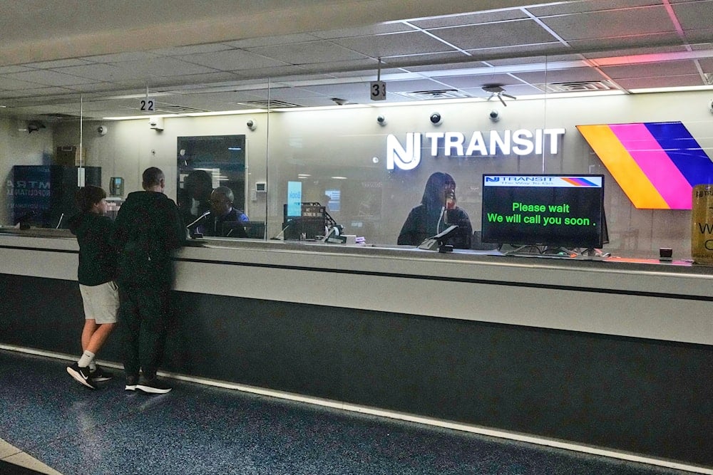 People stand at the train ticket counter of NJ Transit at Penn Station, amid a strike by New Jersey Transit train engineers, in New York, Friday, May 16, 2025. (AP)