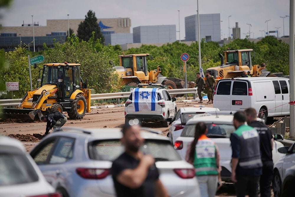 Israeli forces inspect the site where a projectile fired by the Yemeni Armed Forces landed in the area of Ben Gurion International Airport near Tel Aviv, occupied Palestine, on Sunday, May 4, 2025 (AP)