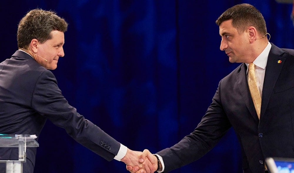 Presidential candidates Nicusor Dan, left, and George Simion gesture during a live electoral debate ahead of the second round of the presidential election redo in Bucharest, Romania, May 9, 2025. (AP)