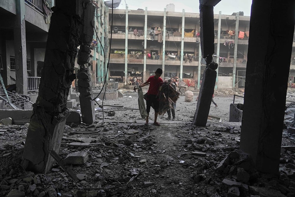 Palestinians inspect the damage at a UN school used as a shelter by displaced residents that was hit by Israeli military strikes, killing more than 15 people, in Jabaliya, northern Gaza Strip, on Monday, May 12, 2025. (AP)