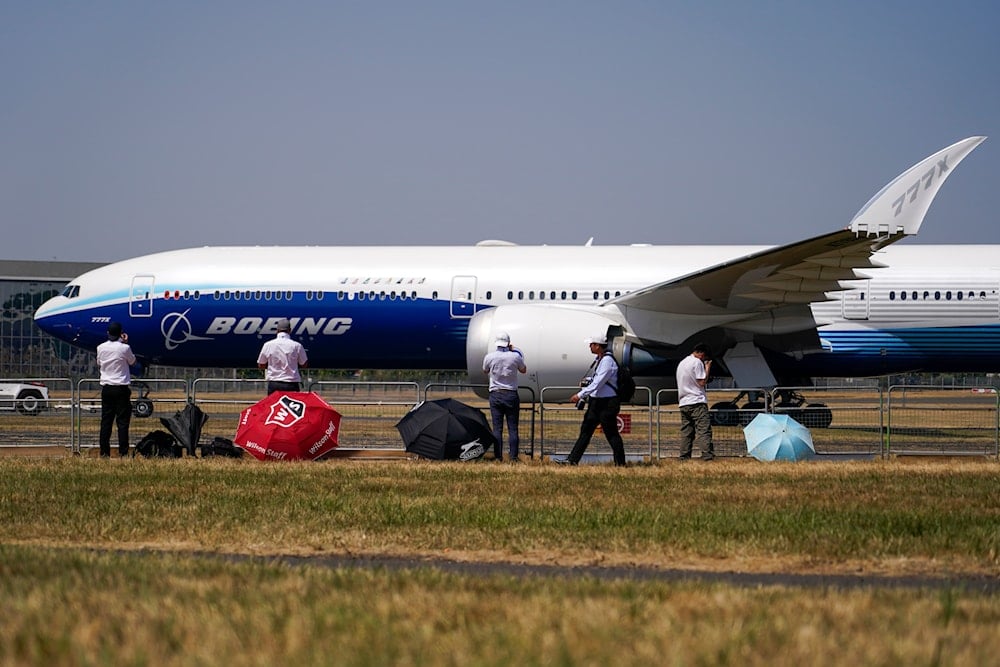 A Boeing 777X is brought on the runway ahead of a display flight, at the Farnborough Air Show fair in Farnborough, England, Tuesday, July 19, 2022 (AP)
