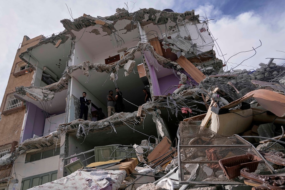 Palestinians inspect a house destroyed by the Israeli army during a raid that killed five Palestinian militants in the West Bank village of Tamun, Thursday, May 15, 2025 (AP)