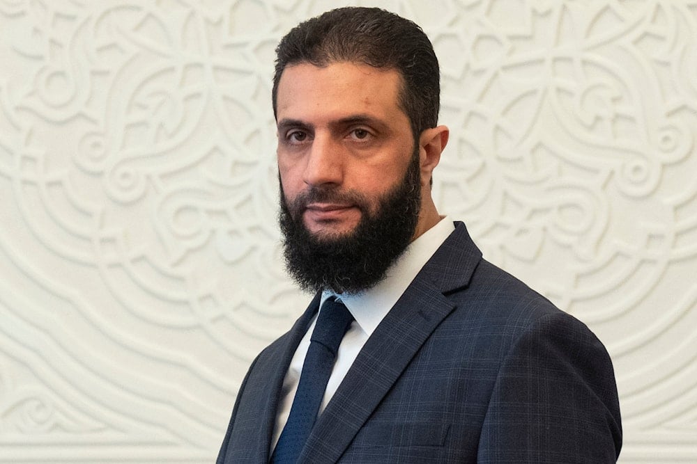 Syria's interim president Ahmad al-Sharaa, walks in the presidential palace ahead of his meeting with Walid Ellafi, Libyan minister of state for communication and political affairs, in Damascus, Dec. 28, 2024 (AP)