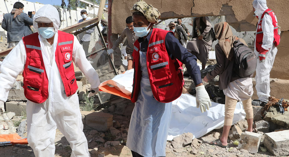 Rescue workers carry the body of a victim from the rubble of a building hit in US strikes in Saada, Yemen, on 28 April 2025 (AFP)