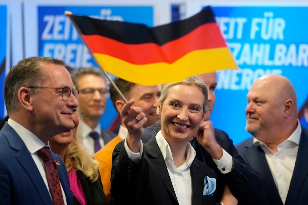 Leader of far right AfD Alice Weidel waves a German flag at the AfD party headquarters in Berlin, Germany, February 23, 2025, after the German national election (AP/Michael Probst)