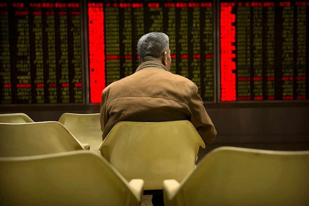 A Chinese investor monitors stock prices at a brokerage house in Beijing, on March 23, 2018. (AP)