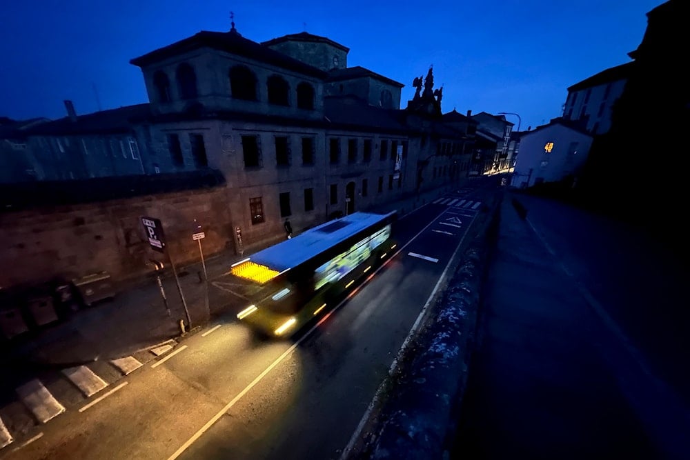 A city bus goes by the historic city of Santiago, Spain during a major power outage across Spain and Portugal on April, 28, 2025. (AP Photo/Mic Smith)