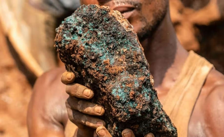 An artisanal miner holds a cobalt stone at the Shabara artisanal mine near Kolwezi (Junior Kannah/AFP)