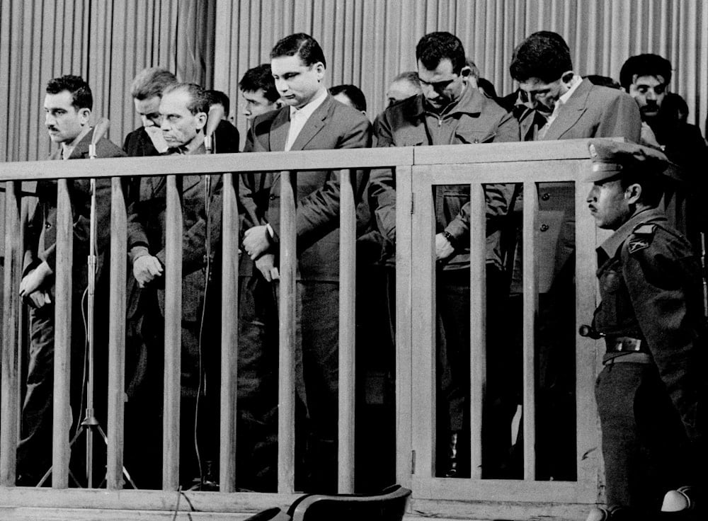 Elie Cohen, far left, head of an Israeli spy ring, listens as he is sentenced to death by a special military court in Damascus, Syria, May 8, 1965 (AP)