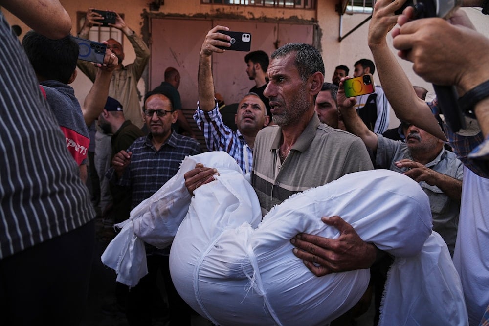 Mohammad Nassar carries the body of his niece Jana Nassar killed in an Israeli army airstrike on the Gaza Strip, during her funeral at Al-Aqsa Hospital in Deir al-Balah, Gaza, Tuesday, May 20, 2025. (AP)