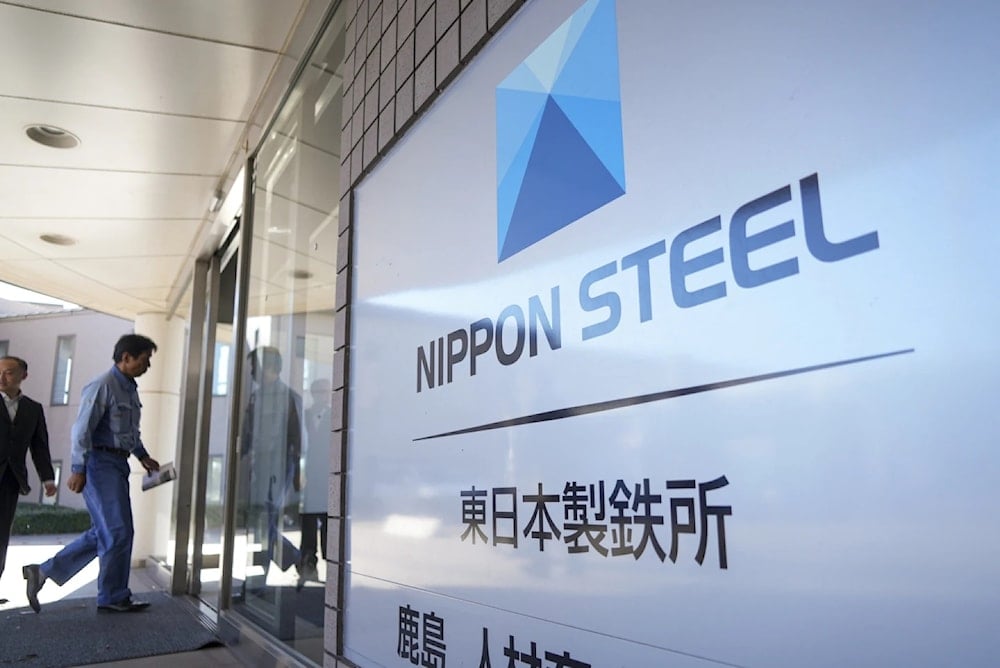 A staff enters doorway next to Nippon Steel logo at the company's Kashima Plant in Kashima, Japan on December 6, 2024 (AP/Ayaka McGill)