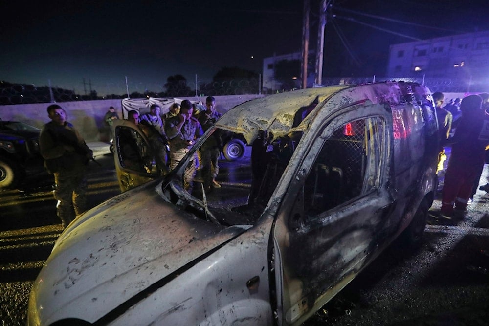 Lebanese army soldiers and rescue workers gather next of a damaged car after an Israeli strike, in the southern port city of Sidon, Lebanon, early Wednesday, May 7, 2025 (AP)