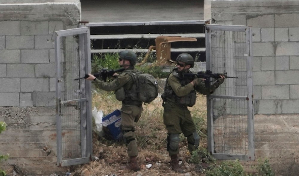 Israeli soldiers raid a Palestinian village next to the West Bank town of Bruqin, Thursday, May 15, 2025. (AP)