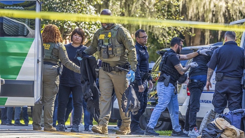 Law Enforcement officers detain migrants in the area in Carol Gables, Florida, January 28, 2025 (Pedro Portal/AP)