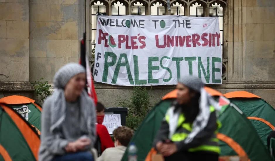 A pro-Palestine banner hangs on a wall of King's College Cambridge, undated (AFP)