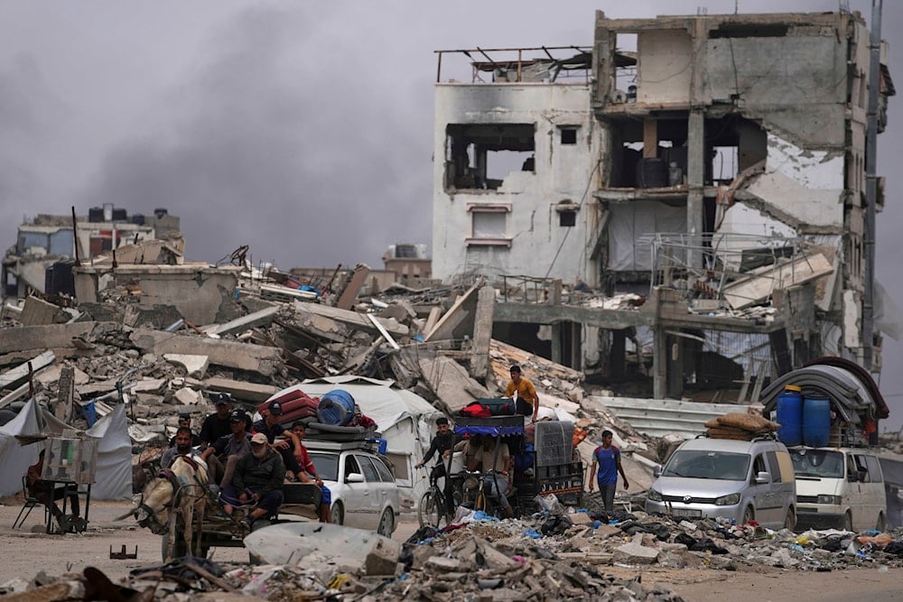 Displaced Palestinians fleeing Beit Lahia amid ongoing Israeli military operations in the Gaza Strip arrive in Jabalia, northern Gaza, on May 18, 2025. (AP Photo/Jehad Alshrafi)