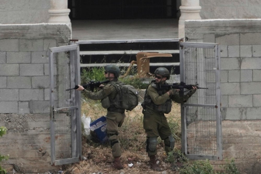 Israeli soldiers search a Palestinian village next to the West Bank settlement of Bruchin, the occupied West Bank, occupied Palestine, Thursday, May 15, 2025 (AP)