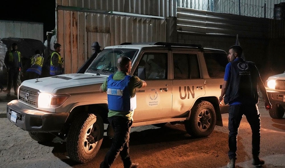 UN vehicles escort aid trucks carrying food as they arrive at a World Food Program warehouse in Zawaida, central Gaza Strip, Wednesday, May 21, 2025. (AP Photo/Abdel Kareem Hana)