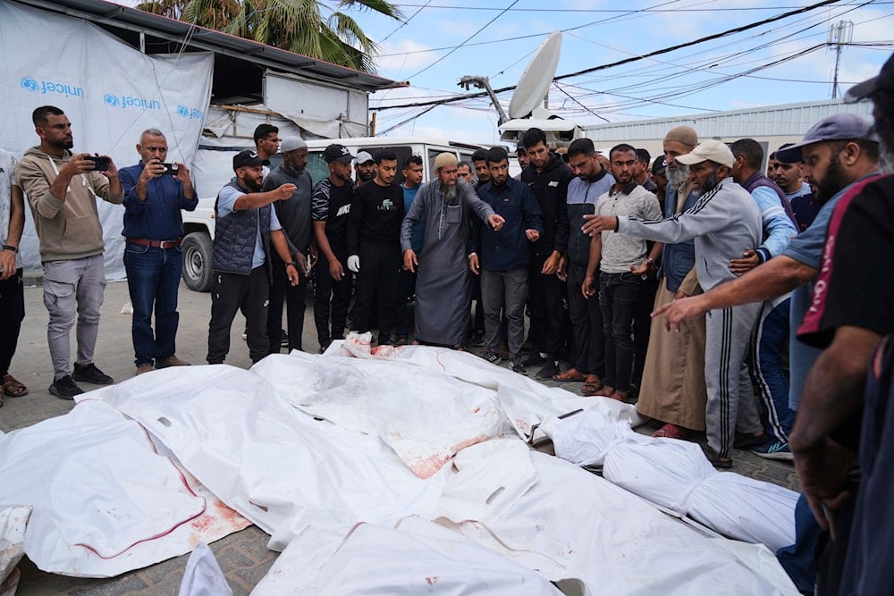Palestinians prepare to bury the victims of an Israeli airstrike on the Gaza Strip, at Al-Aqsa Hospital in Deir al-Balah, Gaza, on May 22, 2025. (AP Photo/Abdel Kareem Hana)